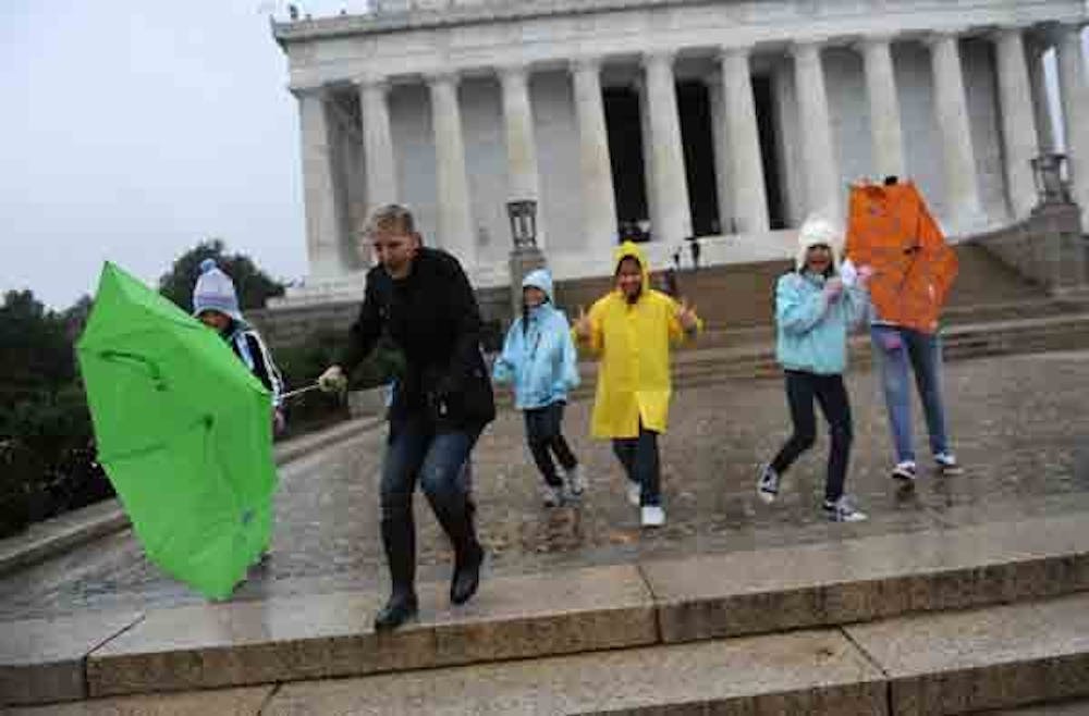 Tourists fight the high winds and rain from Hurricane Sandy, Monday, October 29, 2012, at the Lincoln Memorial in Washington, D.C.
