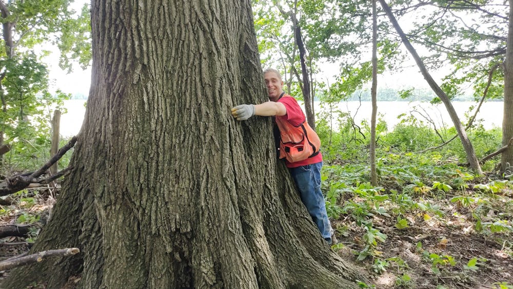 <p>Ball State senior Steve Doll hugs a tree during his and the Department of Biology&#x27;s field work. Doll is a Udall Scholarship awardee and the President of the Ball State Wildlife Society. John Taylor, Photo Provided</p>