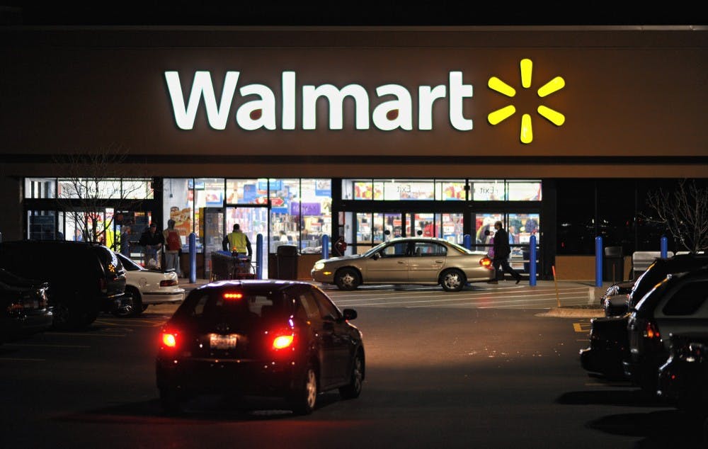 Customers shop at the newly remodeled Wal-Mart in Eagan, Minnesota, December 2, 2009. Minnesota, where Target has 74 stores, the bulk of them in the metro area, has always been one of the most profitable regions for the Minneapolis-based retailer. "Wal-Mart wants to beat Target on its own turf," said Burt P. Flickinger III, managing director of Strategic Resource Group. (Glen Stubbe/Minneapolis Star Tribune/MCT)