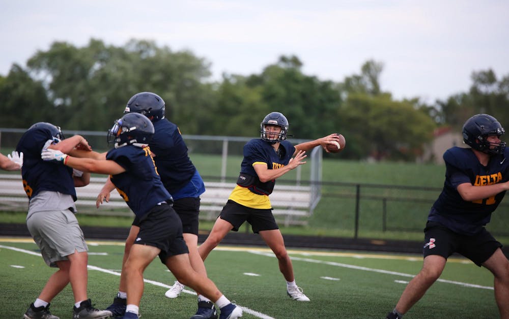 <p>Delta senior Bronson Edwards throws July 16 during a practice at Delta High School. Edwards threw for 1,754 passing yards in 2023. Zach Carter, DN.</p>