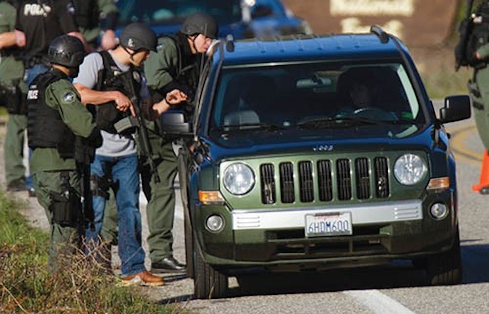 SWAT officers check cars driving south on Highway 38, 20 miles south of where a gun battle took place between fugitive Christopher Dorner and police Feb. 12, 2013. MCT PHOTO