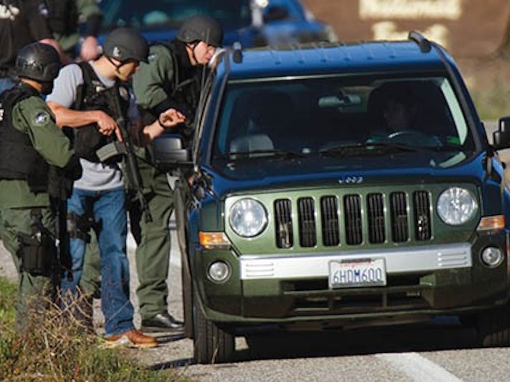 SWAT officers check cars driving south on Highway 38, 20 miles south of where a gun battle took place between fugitive Christopher Dorner and police Feb. 12, 2013. MCT PHOTO