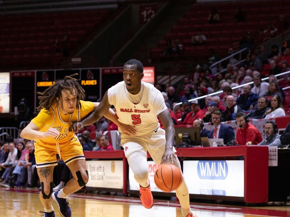Junior guard Davion Bailey looks to pass the ball during the game against Kent State Mar. 5 at Worthen Arena. Bailey had seven rebounds during the game. Kate Tilbury, DN