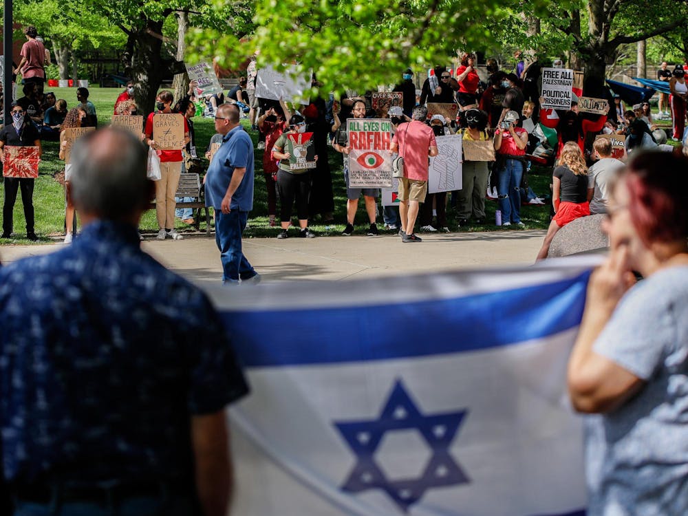 Counter-protesters stand across from student protesters holding the flag of Israel May 1st at Frog Baby Fountain. Andrew Berger, DN