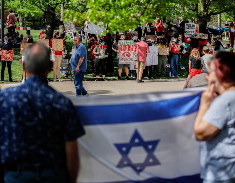 Counter-protesters stand across from student protesters holding the flag of Israel May 1st at Frog Baby Fountain. Andrew Berger, DN