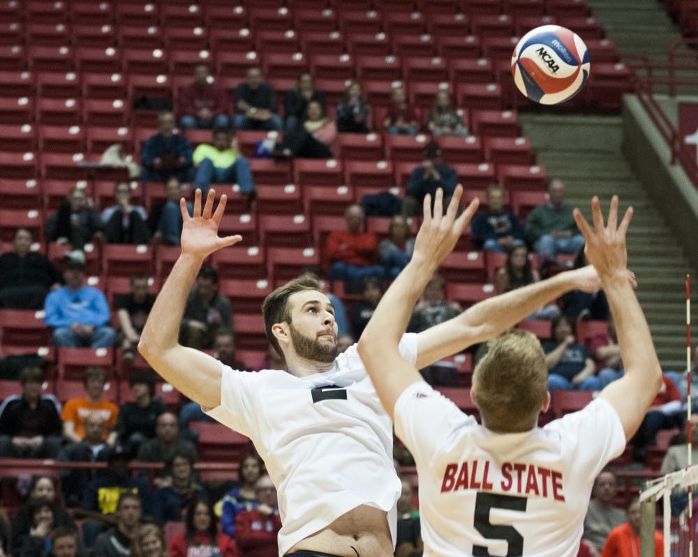 Senior setter Graham McIlvaine sets up the ball for senior middle attacker Matt Leske during the game against Lewis on March 29. Ball State dropped the game, 3-2. DN PHOTO JONATHAN MIKSANEK