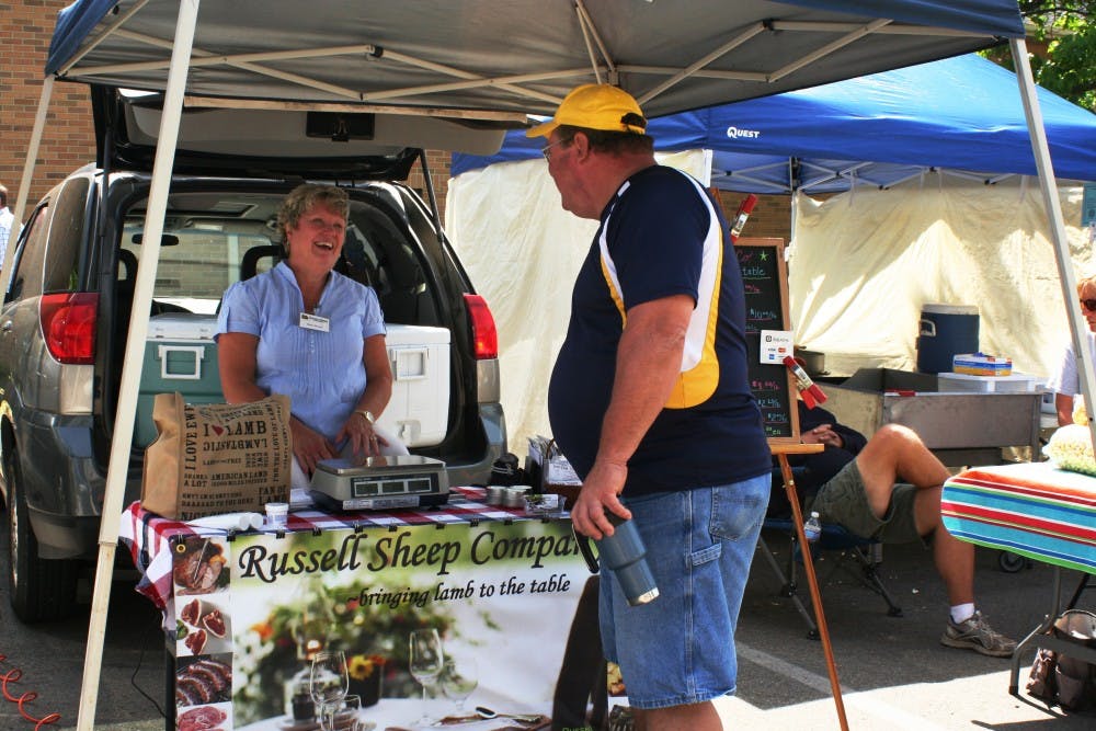 Diane Russell of Russell Sheep Company talks with a customer at the Minnetrista Farmers Market. Her company is based in Eaton, Ind., about 16 minutes away from Minnetrista. DN PHOTO ASHLEY DYE