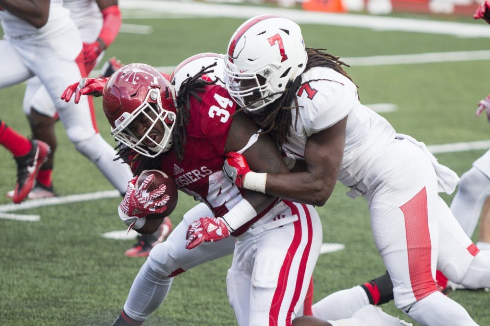 Ball State senior linebacker Aaron Taylor makes a tackle on Indiana running back Devine Redding during the Cardinals' 30-20 loss at Memorial Stadium on Sept. 10. Taylor led the team with&nbsp;13 total tackles in the game. DN Photo // Grace Hollars