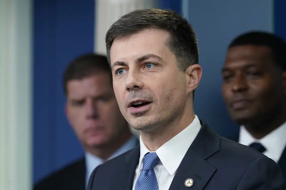 FILE - Transportation Secretary Pete Buttigieg, center, speaks during a briefing at the White House in Washington, May 16, 2022, as Labor Secretary Marty Walsh, left, and Environmental Protection Agency administrator Michael Regan, right, listen. The Biden administration is saying the U.S. economy would face a severe economic shock if senators don&#x27;t pass legislation this week to avert a rail worker strike. Walsh and Buttigieg are meeting with Democratic senators Thursday, Dec. 1, to underscore that rail companies will begin shuttering operations well before a potential strike begins on Dec. 9. (AP Photo/Susan Walsh, File)
