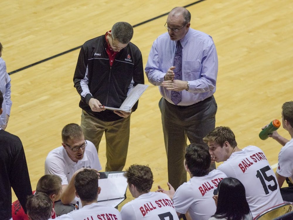 Head coach Joel Walton and assistant coach Kevin Furnish talk to the men's volleyball team during a timeout in the game against Penn State on Jan. 16 at Worthen Arena. DN PHOTO BREANNA DAUGHERTY