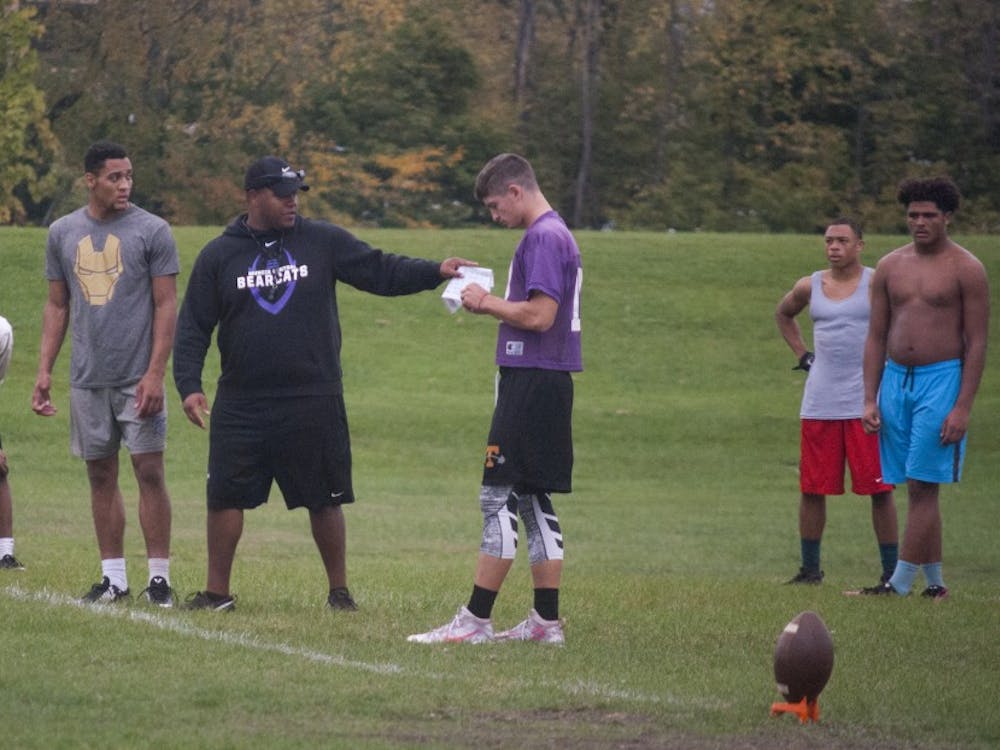 Muncie Central head football coach Adam Morris works on onside kicks with his team. Morris played football at Ball State from 2008-2011. DN//Colin Grylls