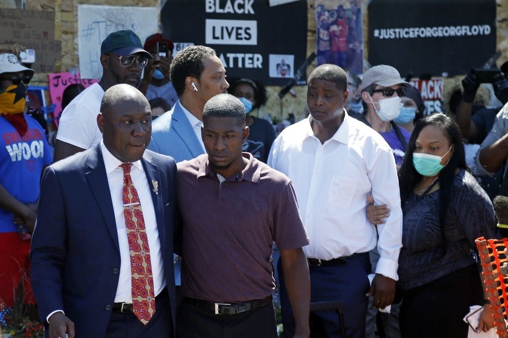 <p>Family attorney Ben Crump, left, escorts Quincy Mason, second from left, a son of George Floyd, Wednesday, June 3, 2020, in Minneapolis, as they and some Floyd family members visited a memorial where Floyd was arrested on May 25 and died while in police custody. Video shared online by a bystander showed a white officer kneeling on his neck during his arrest as he pleaded that he couldn't breathe.<strong> (AP Photo/Jim Mone)</strong></p>