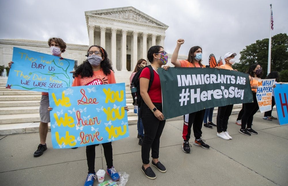 Deferred Action for Childhood Arrivals (DACA) students celebrate in front of the U.S. Supreme Court after the Supreme Court rejects President Donald Trump's bid to end legal protections for young immigrants, Thursday, June 18, 2020, in Washington. (AP Photo/Manuel Balce Ceneta)