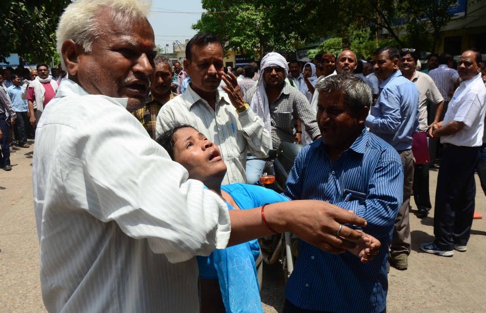 People carry a woman toward hospital after she got unconscious during the earthquake tremors on May 12, 2015 in Allahabad, India. A massive earthquake of magnitude 7.4 hit Nepal capital Kathmandu on Tuesday triggering strong tremors which were felt across Delhi and other parts of north India. (Prabhat Kumar Verma/Pacific Press/Zuma Press/TNS)