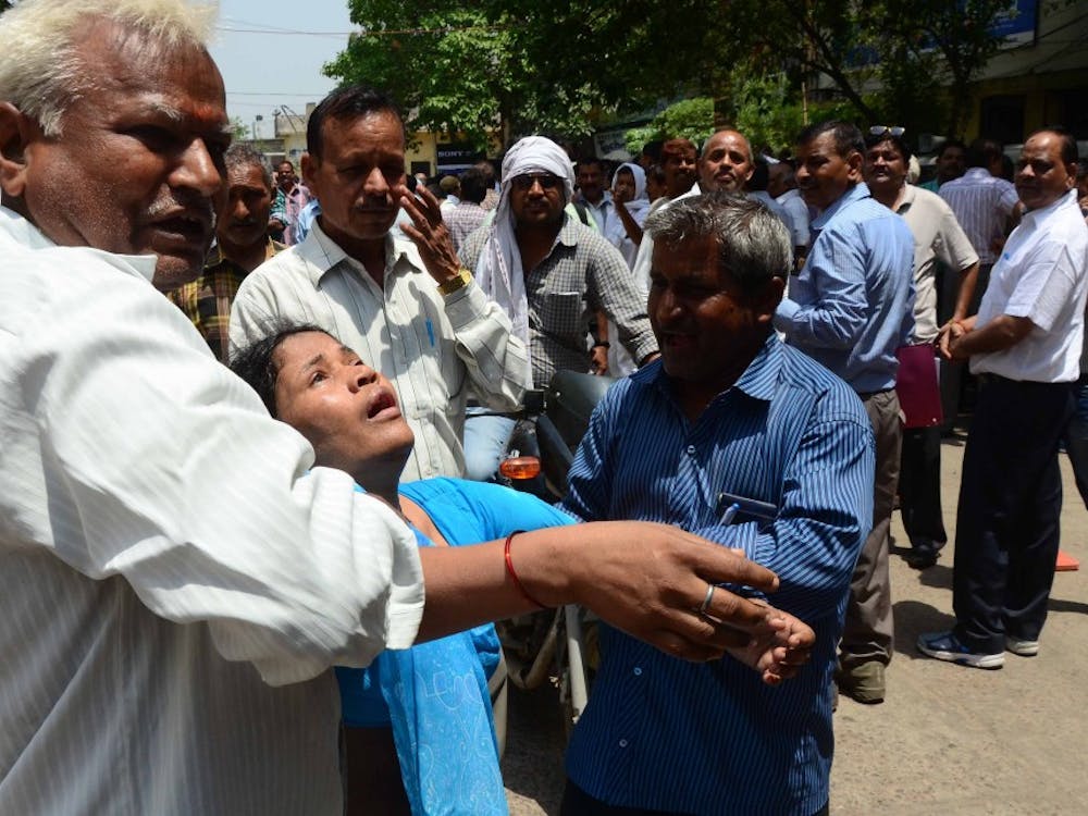 People carry a woman toward hospital after she got unconscious during the earthquake tremors on May 12, 2015 in Allahabad, India. A massive earthquake of magnitude 7.4 hit Nepal capital Kathmandu on Tuesday triggering strong tremors which were felt across Delhi and other parts of north India. (Prabhat Kumar Verma/Pacific Press/Zuma Press/TNS)