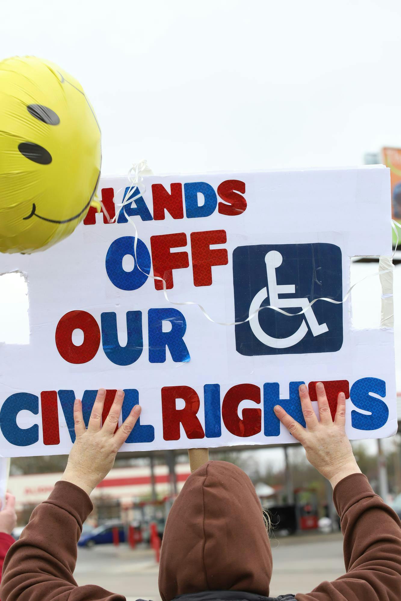 A protester stands on the streets of Muncie at the crossing of McGalliard and Wheeling April 5 during the "Hands Off" protest. Muncie Resists estimates over 400 people where in attendance. Olivia Ground, DN