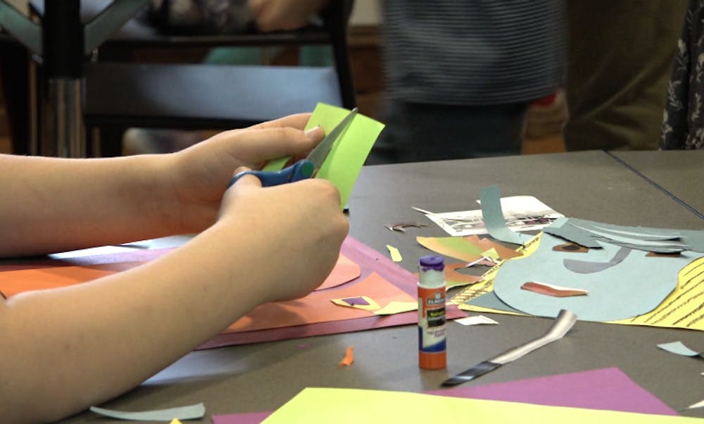 Student making a collage after walking through DOMA.
