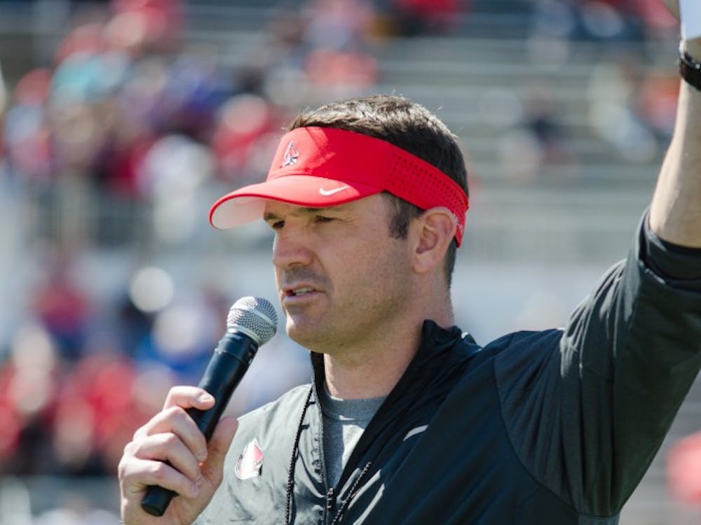 Head Coach Mike Neu introduces the football staff to the audience at the spring game on April 23 at Scheumann Stadium. DN PHOTO KELLEN HAZELIP