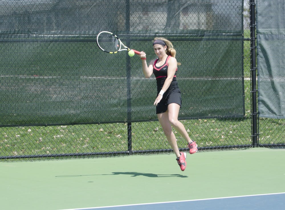 Junior Courtney Wild hits the ball to her opponent during her doubles match against Bowling Green on April 18 at Cardinal Creek Tennis Center. Courtney Wild earned an Academic All-MAC honor. DN FILE PHOTO BREANNA DAUGHERTY