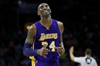 In this Dec. 1, 2015 file photo Los Angeles Lakers' Kobe Bryant smiles as he jogs to the bench during the first half of an NBA basketball game against the Philadelphia 76ers in Philadelphia. The Retired NBA superstar has died in helicopter crash in Southern California, Sunday, Jan. 26, 2020. (AP Photo/Matt Slocum)