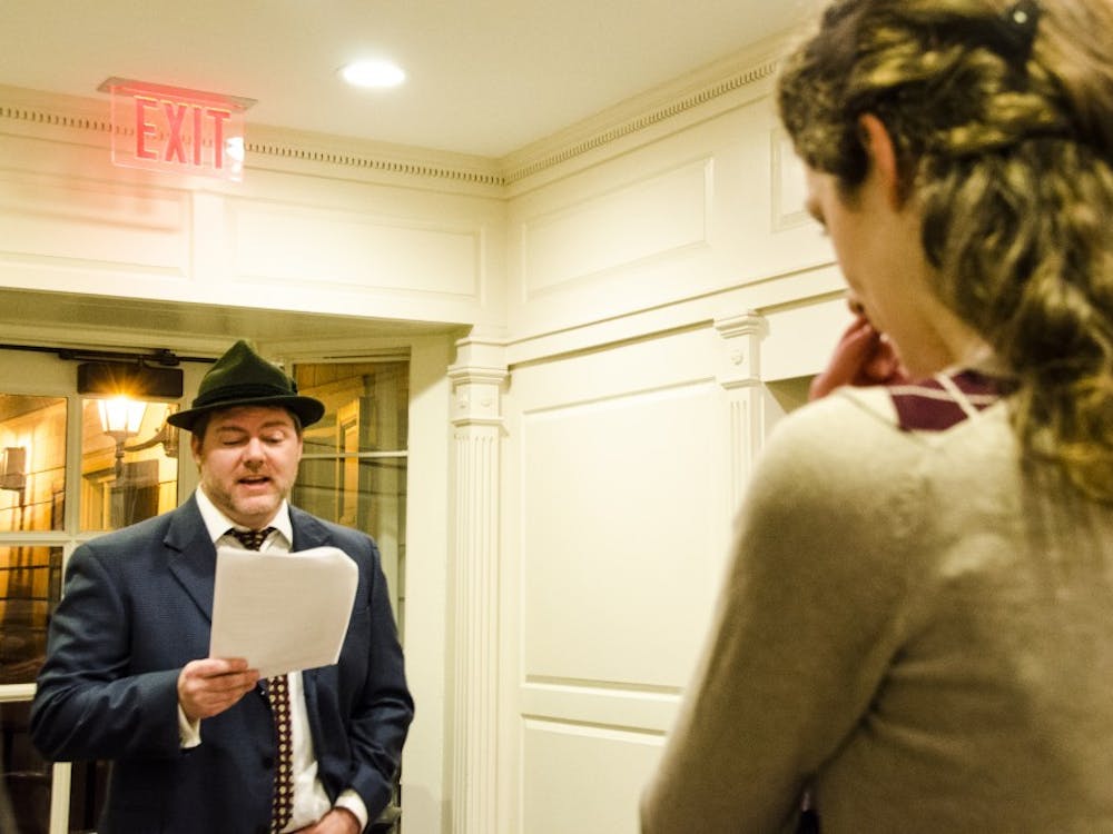 Assistant English professor Brett Blackwell plays Detective inspector Lestrade at the honors murder mystery party. DN PHOTO KELSEY DICKESON