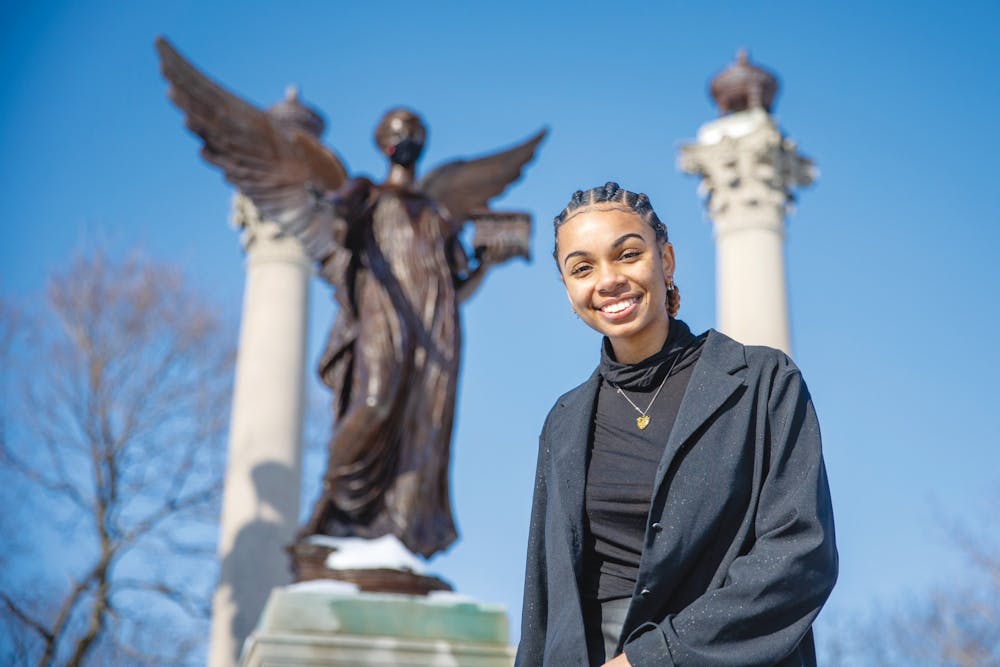 Senior public communications major Taylor Hall poses for a portrait in front of the Beneficence statue Feb. 19, 2021, in the Quad. Hall is the founder of Artivist LLC, a community outreach program. Kristen Triplett, DN