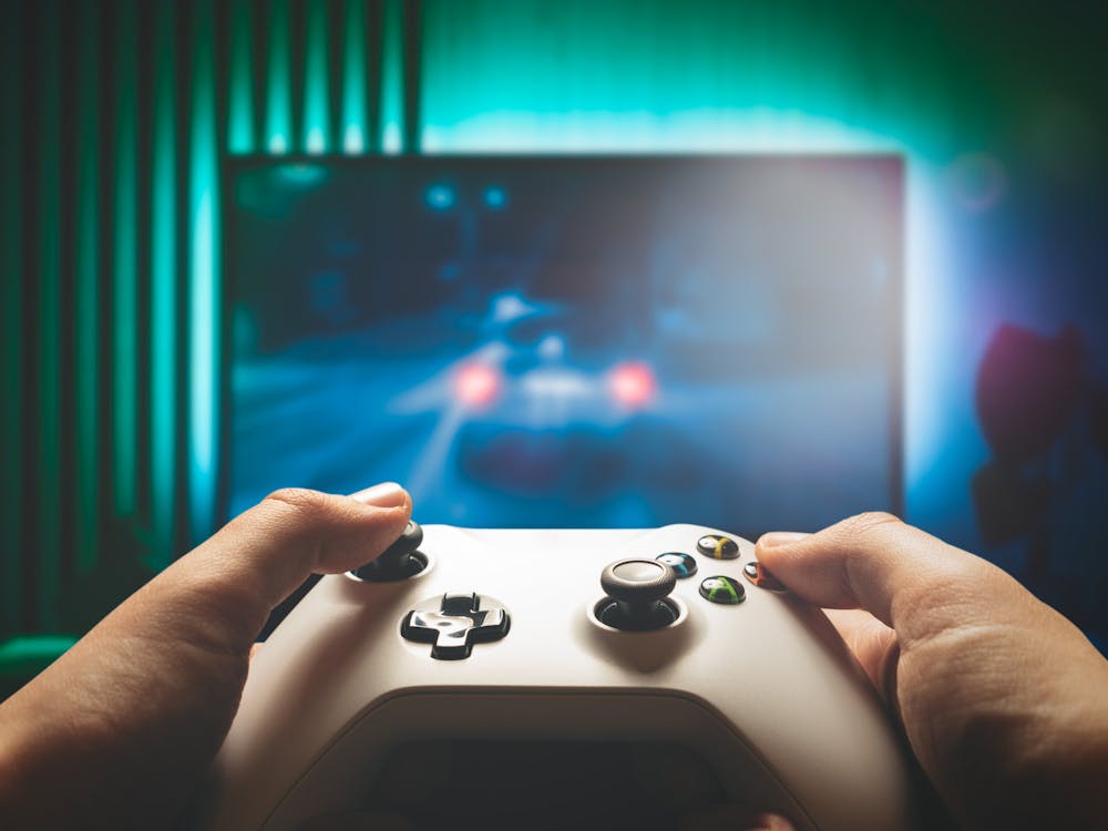 Video game controller, gaming concept with TV screen in background