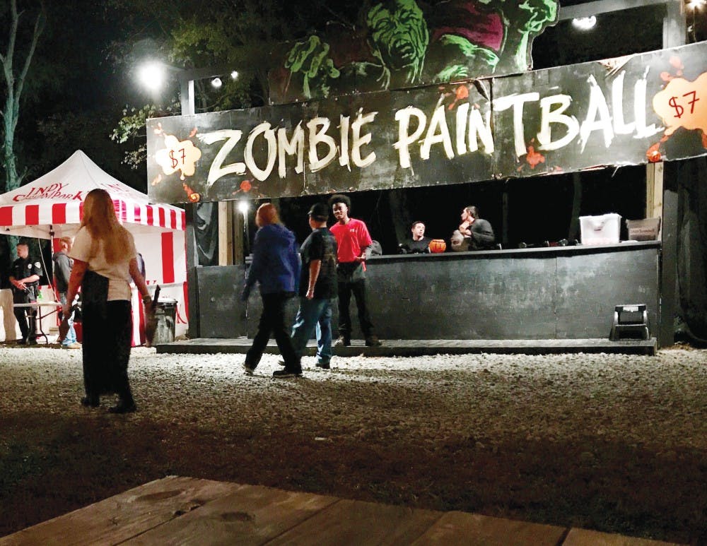 Guests walk past Zombie Paintball at Indy Scream Park in Anderson, Indiana. This is the park’s 18th season. Victoria Breeding, DN