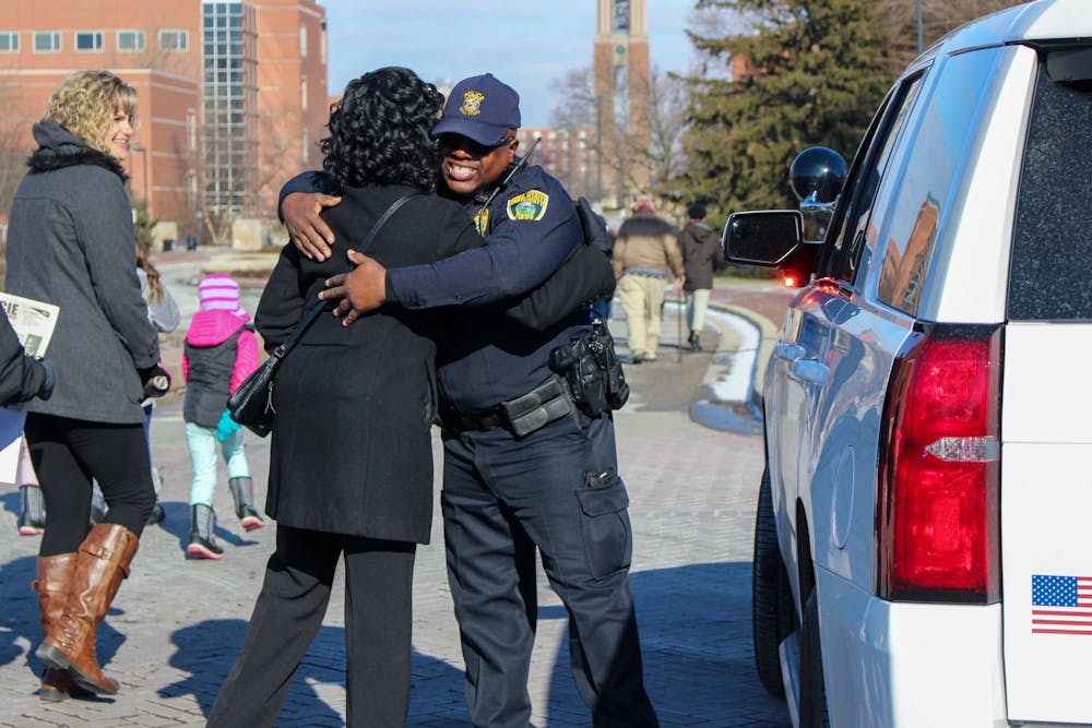 <p>University Police Department Lt. Terrell Smith hugs a participant Jan. 20, 2020, during the MLK Unity March. UPD helped direct the traffic on McKinley Avenue during the march. <strong>Bailey Cline, DN</strong></p>