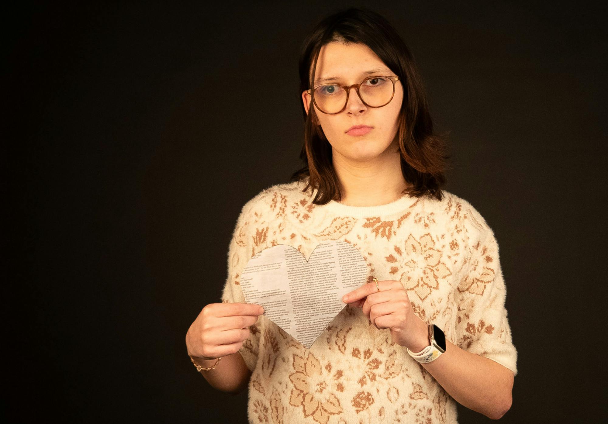 Second-year journalism major Katherine Hill holds a newspaper heart for a portrait Jan. 27 at the Arts and Journalism Building. Hill believes that empathy is the cornerstone of good journalism. LJ Barnes, DN