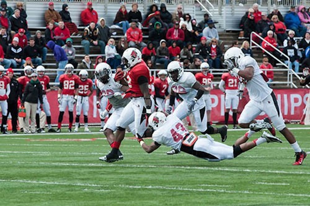 Jahwan Edwards is tackled by Martez Hester during the Spring Game at Scheumann Stadium on April 20, 2013. DN PHOTO TAYLOR IRBY 