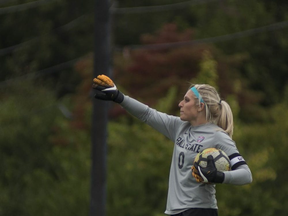 Senior goalkeeper Alyssa Heintschel yells to her teammates before putting the ball back into play against Northern Illinois on Oct. 8 at the Briner Sports Complex. Heintschel had five saves in the game. Breanna Daugherty, DN
