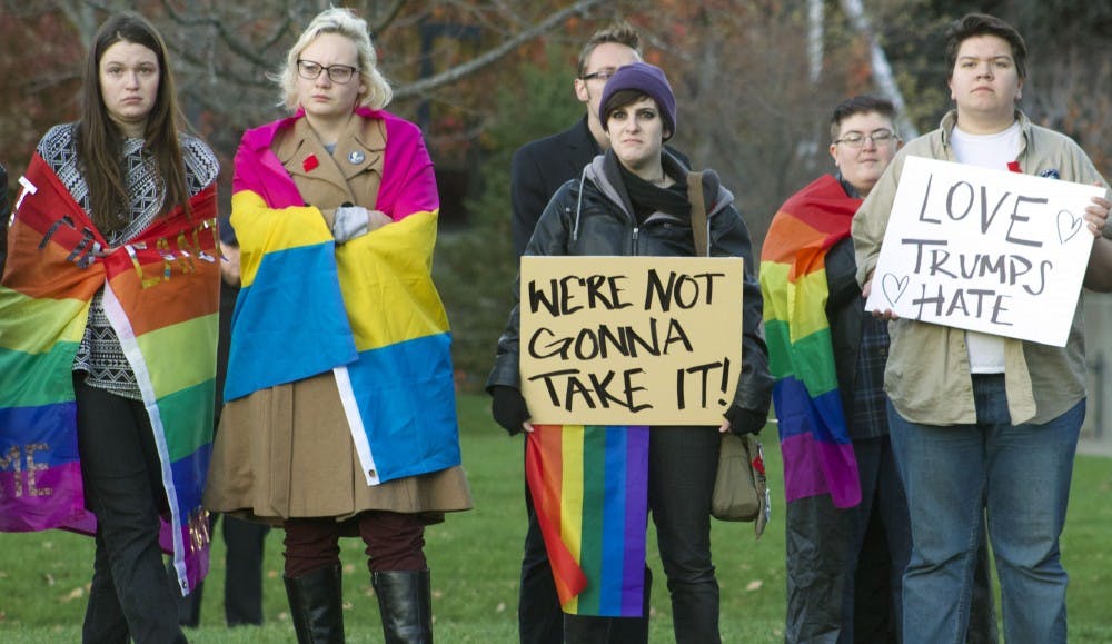 A group of protestors stand with their signs at a rally to protest president-elect Donald Trump on Nov. 9. Kara Berg//DN