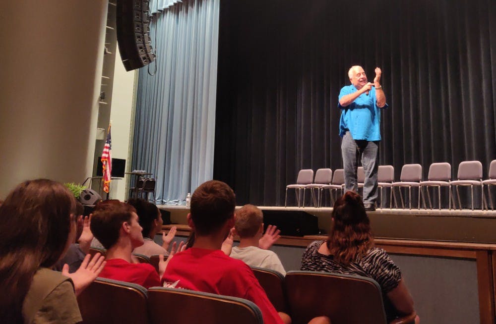 Dan Larosa instructs students in the audience to watch their hands closely Aug. 16, 2019, at his hypnosis show at Emens Auditorium. Larosa said he has performed at Ball State for over 30 years. Rohith Rao, DN