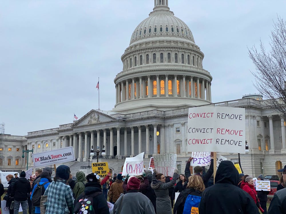 <p>Protesters hold signs outside the White House after President Donald Trump was acquitted on the two counts of impeachment Feb. 5, 2020, in Washington D.C. <strong>Emily Wright, DN</strong></p>
