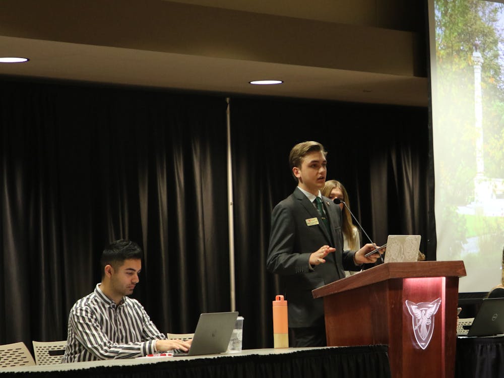 Joseph Gassensmith gives his executive report in the L.A. Pittenger Student Center ballroom Feb. 22. He announced the closing of the Homecoming Steering Committee applications as well as his communication with the University Police Department about a blue light map. Madelyn Bracken, DN