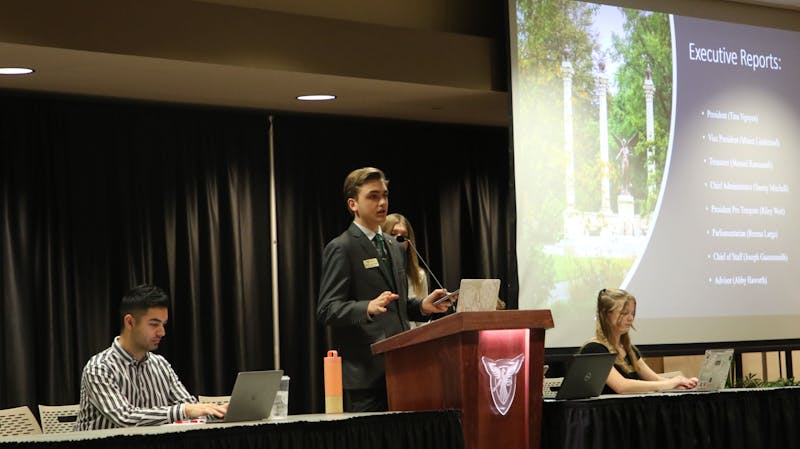 Joseph Gassensmith gives his executive report in the L.A. Pittenger Student Center ballroom Feb. 22. He announced the closing of the Homecoming Steering Committee applications as well as his communication with the University Police Department about a blue light map. Madelyn Bracken, DN