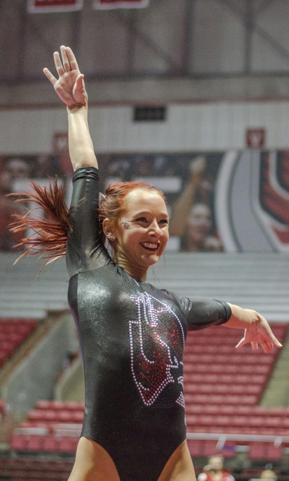 Junior Shelby Arms strikes a pose during her floor routine during the meet against Eastern Michigan and Illinois State on Jan. 24 in Worthen Arena. DN PHOTO BREANNA DAUGHERTY