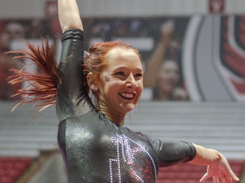 Junior Shelby Arms strikes a pose during her floor routine during the meet against Eastern Michigan and Illinois State on Jan. 24 in Worthen Arena. DN PHOTO BREANNA DAUGHERTY