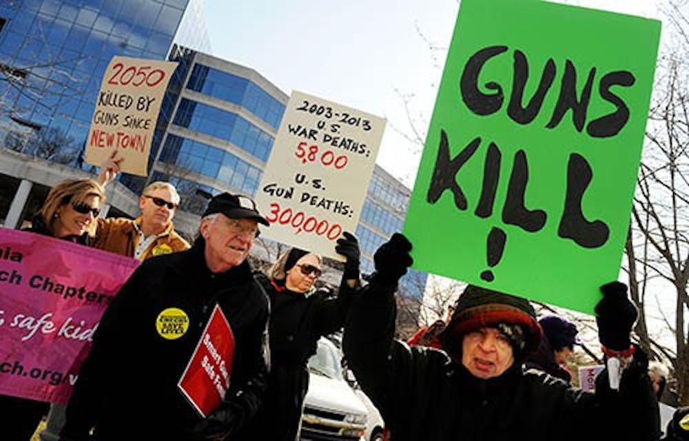 MomsRising holds a rally in front of the National Rifle Association office, in support of common-sense gun regulations on March 14 in Fairfax, Va. The debate over gun control has gained national attention after the Newtown shootings in December 2012. MCT PHOTO