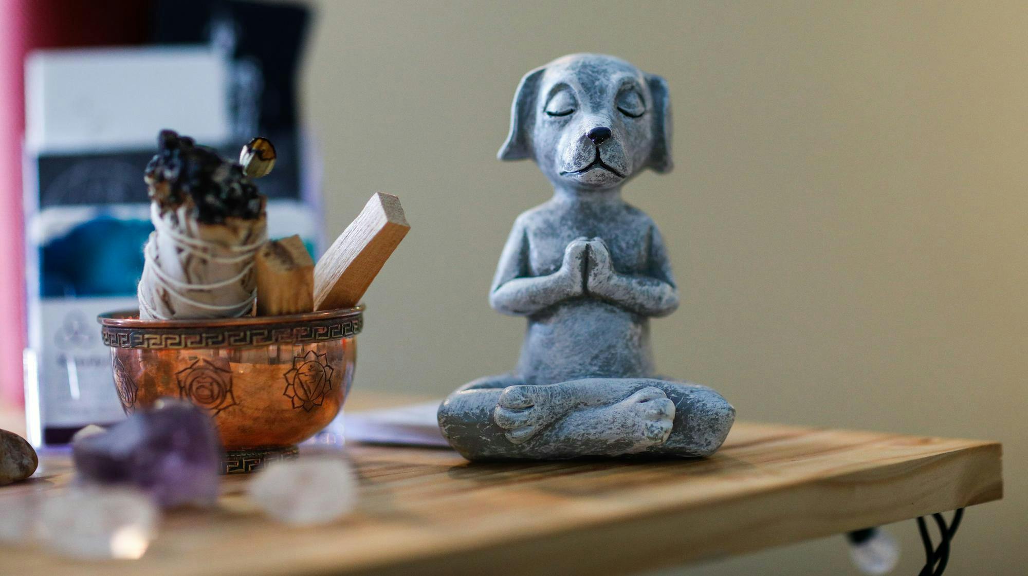 Yoga inspired figurines and gems litter the desk Feb. 20 at Sacred Steps. Sacred Steps teaches Vinyasa, Restorative, and Yin yoga. Andrew Berger, DN 