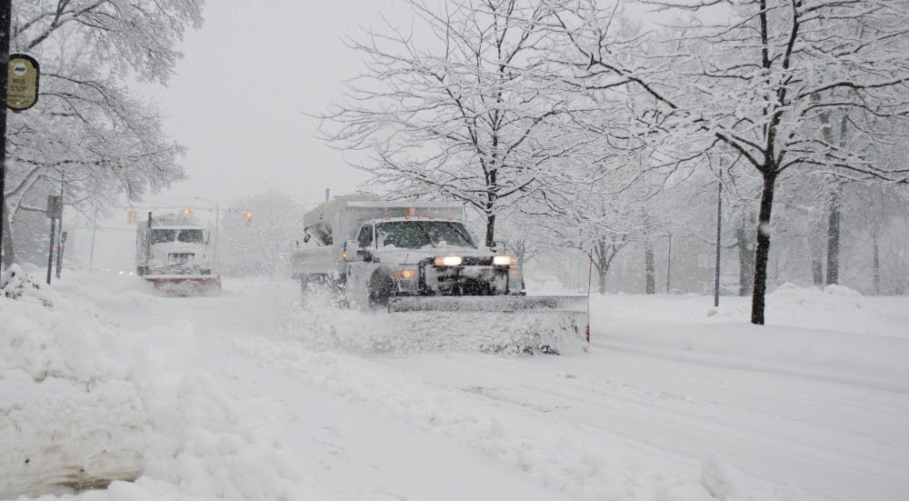 Snow plows work to cover the roads Sunday on West University Avenue in front of the L.A. Pittenger Student Center. DN PHOTO BREANNA DAUGHERTY