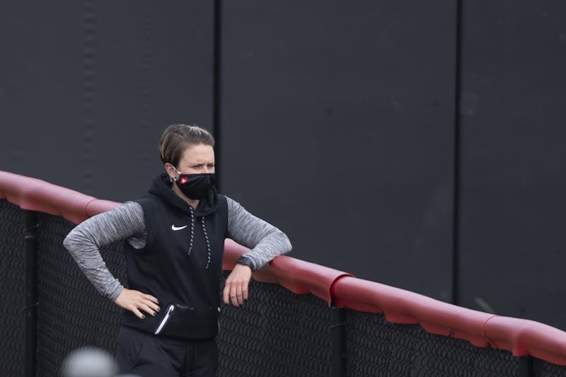 Softball head coach Lacy Wood watches her team practice March 17, 2021, at First Merchants Ballpark Complex. In Wood’s time at Harvard, the team went 101-81. Jacob Musselman, DN