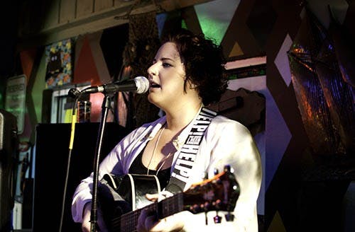 Emily Myren stands at the front of Be Here Now as the first of several performers at Tuesday’s Open Mic Night. Emily Myren, a student at Ball State, runs Open Mic Night, an event that features students, local artists and bands who stop in during their tours.  DN PHOTO RJ RICKER