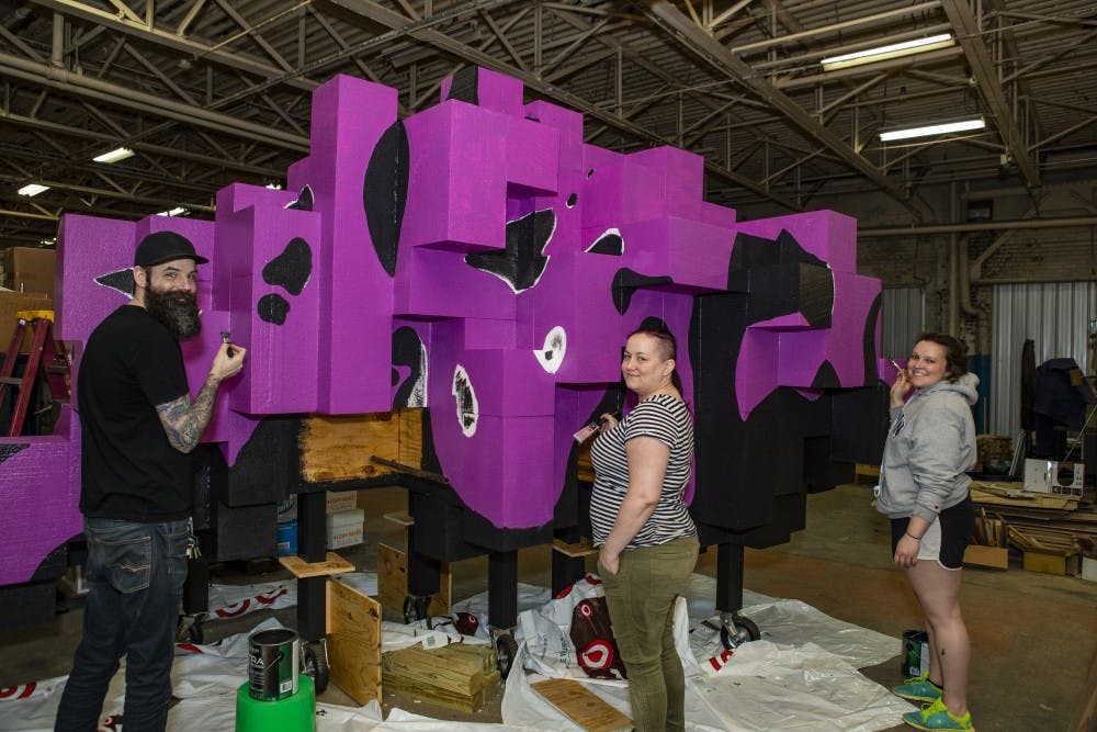 <p>James Kerestes, Lauren Hunter and Katie Gordon paint “Flock” April 30. Hunter and Kerestes worked on the installation for two semesters and Gordon joined the project in the spring semester. <strong>Don Rogers, Photo Provided</strong></p>