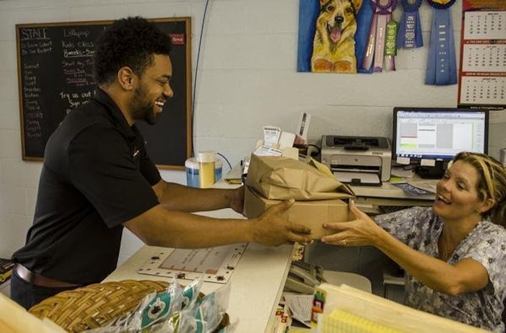 <p>Owner Jordan Presley delivers food to a customer at work. <em>PHOTO PROVIDED BY TRANZIND DELIVERY</em></p>