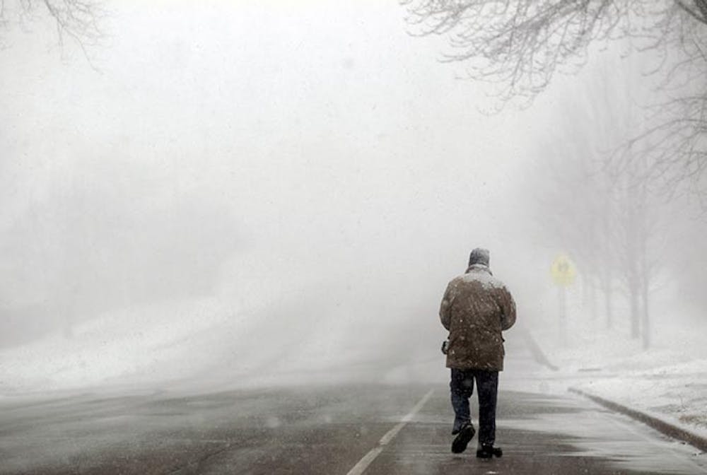 Ken Cioe of Schaumburg, Illinois, walks along Bode Road in Schaumburg through the snow, enroute to his brother&apos;s home on Tuesday, February 26, 2013.   (Stacey Wescott/Chicago Tribune/MCT)