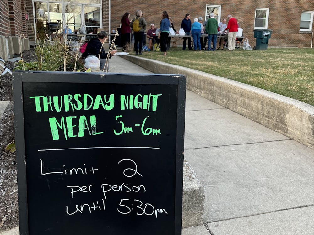 A sign for a Thursday night meal is set up outside of Avondale United Methodist Church in Muncie, Ind., Nov. 10, 2022. The corner of S. Sampson Avenue and W. Tenth Street plays host to this weekly event that provides food for the Muncie community. Kyle Smedley, DN