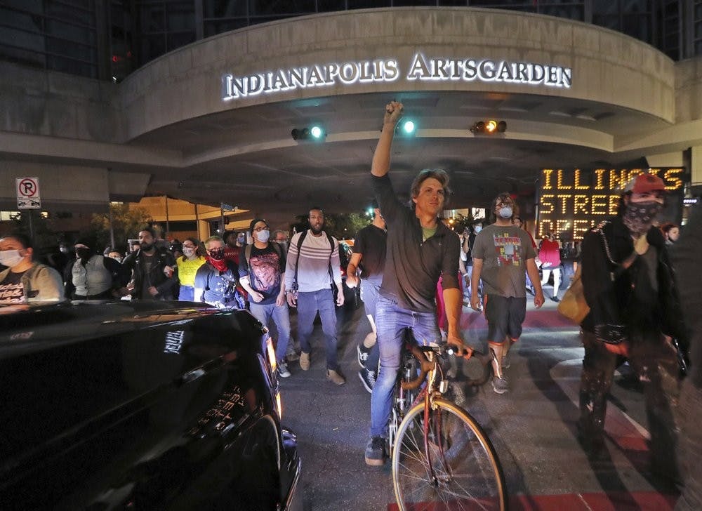 <p>People protest the death of George Floyd, a handcuffed black man in police custody on Memorial Day in Minneapolis, May 29, 2020, in Indianapolis. The protest comes after a series of prominent black deaths that have inflamed racial tensions across the United States. <strong>(Kelly Wilkinson/The Indianapolis Star via AP)</strong></p>