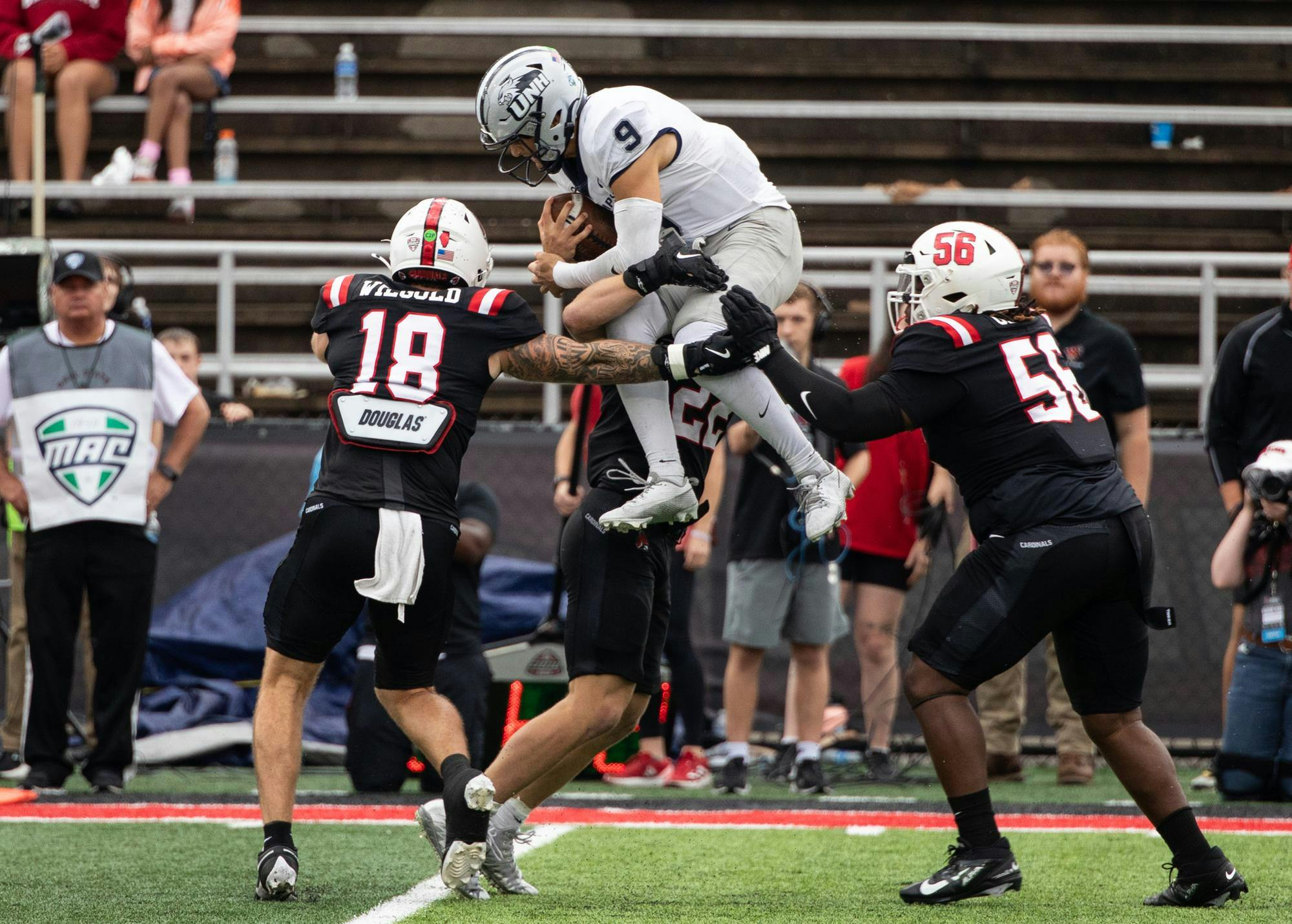 New Hampshire sophomore quarterback Matt Vezza attempts to jump over the Ball State defense Sept. 13 at Scheumann Stadium. Andrew Berger, DN 